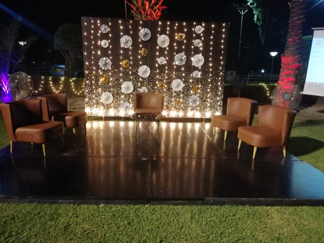 Modern gala night VIP lounge seating with fairy-light backdrop by Events by Momin, gala night event planner in Liaqatpur