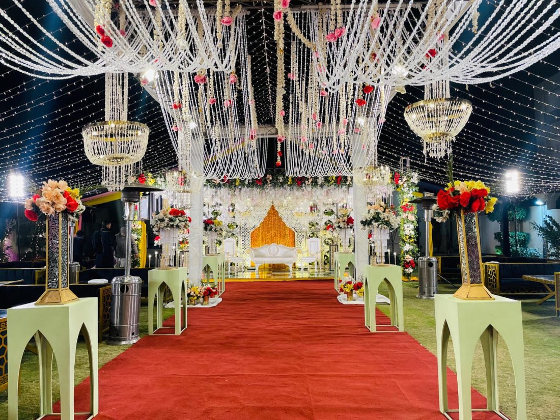 Crystal chandelier red carpet entrance aisle decoration by Events by Momin, top event management company in Sadiqabad