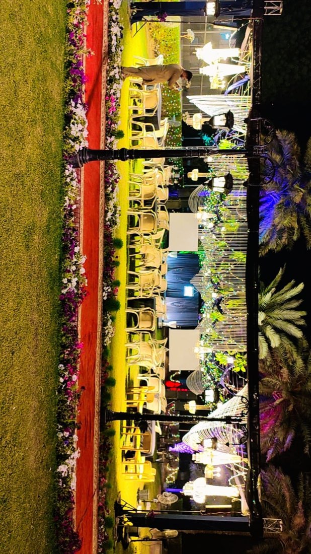 Rustic gears-themed mehndi night stage with colourful bunting by Events by Momin, mehndi stage decorator in Goth Machi