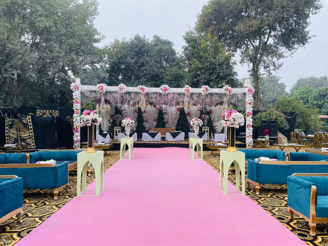 Pink-carpet wedding stage and floral mandap decoration by Events by Momin, the top wedding planner in Rahim Yar Khan